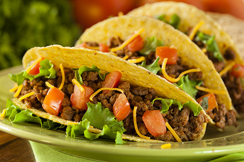 lean ground beef in tacos on green plate